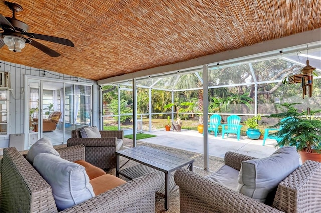 sunroom featuring ceiling fan and wood ceiling