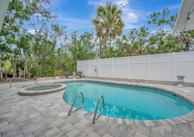 view of swimming pool with an in ground hot tub and a patio