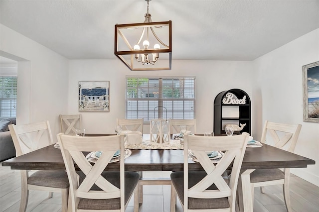 dining room with a wealth of natural light and an inviting chandelier