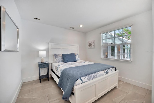 bedroom with light tile patterned floors