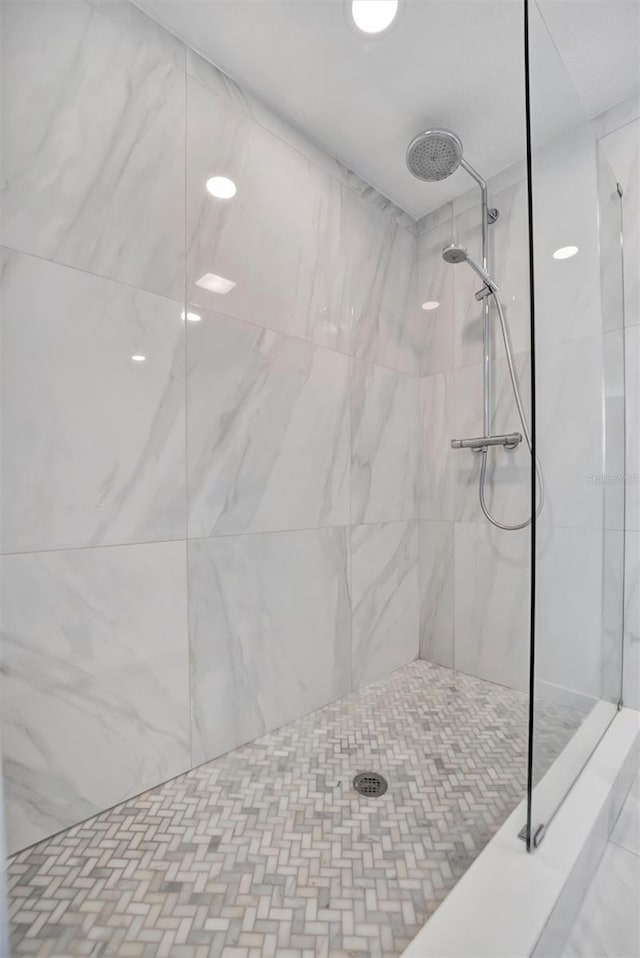 bathroom with a tile shower