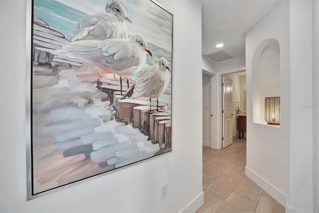 hall featuring light tile patterned flooring