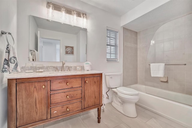 full bathroom featuring tiled shower / bath combo, vanity, tile patterned flooring, and toilet