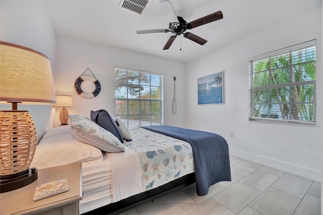 tiled bedroom with ceiling fan