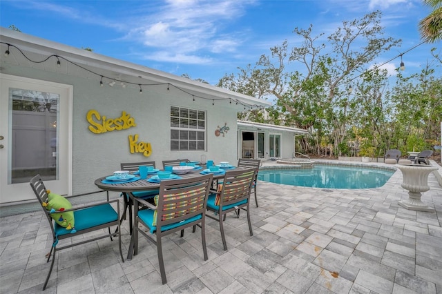 view of pool with a patio and a jacuzzi