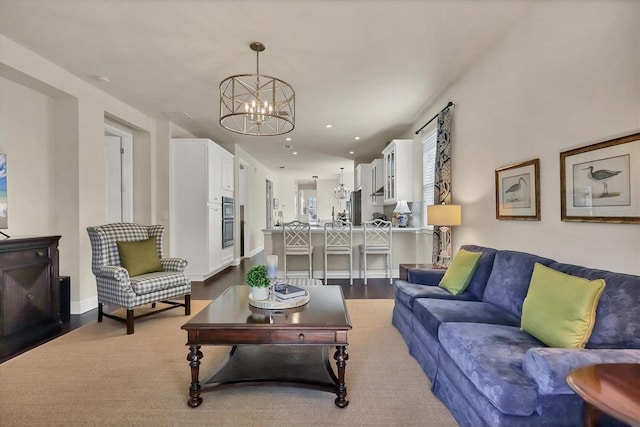 living room with a notable chandelier and wood-type flooring