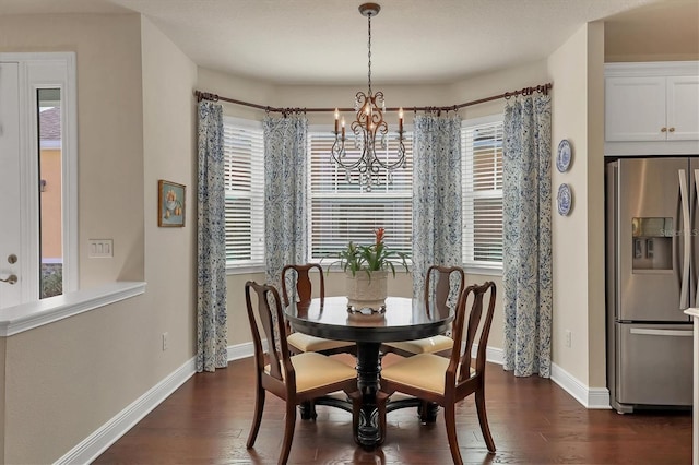 dining area with dark hardwood / wood-style floors and a chandelier