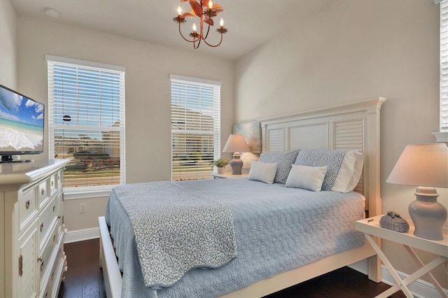 bedroom featuring a notable chandelier and dark hardwood / wood-style floors