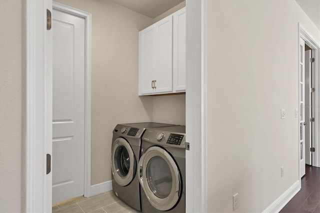 laundry area featuring cabinets and washer and clothes dryer