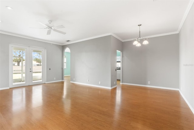 unfurnished room featuring crown molding, ceiling fan with notable chandelier, french doors, and light wood-type flooring