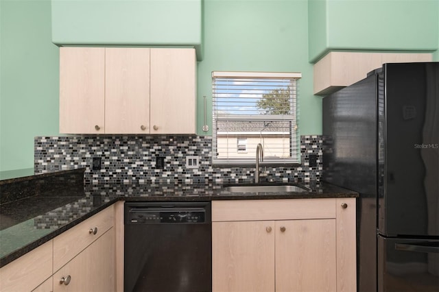 kitchen with dark stone countertops, black appliances, and light brown cabinets