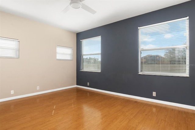 empty room with hardwood / wood-style flooring and ceiling fan