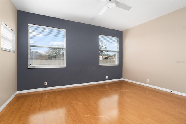 unfurnished room featuring hardwood / wood-style flooring and ceiling fan