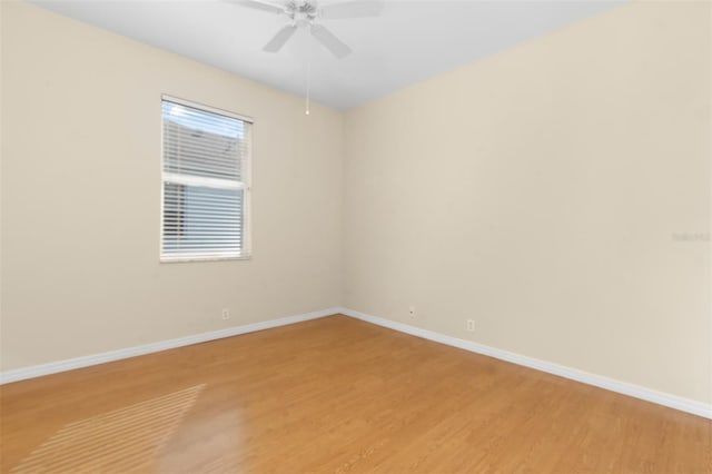 empty room featuring hardwood / wood-style floors and ceiling fan