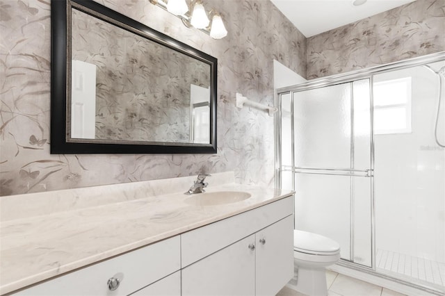 bathroom with an enclosed shower, vanity, tile patterned floors, and toilet