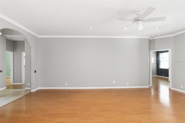 spare room with crown molding, ceiling fan, and light wood-type flooring