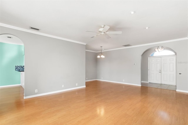 interior space with crown molding, ceiling fan, and light hardwood / wood-style flooring