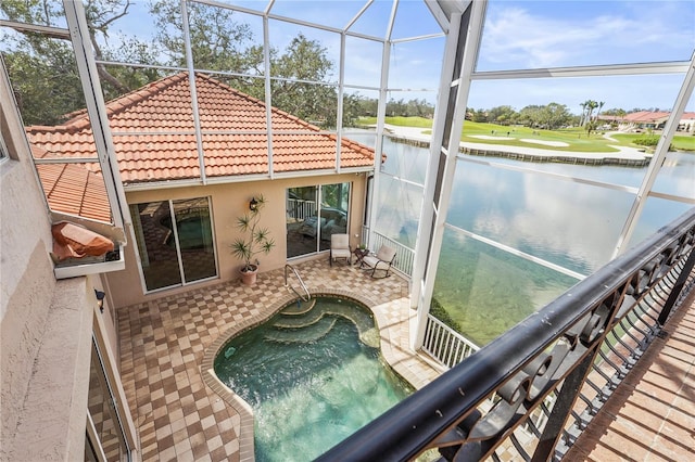 sunroom with a water view and a jacuzzi