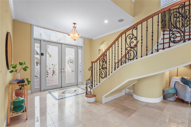 entryway featuring ornamental molding, french doors, stairs, and baseboards