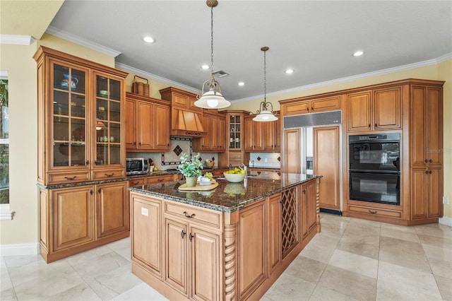 kitchen with dark stone counters, black appliances, glass insert cabinets, and decorative light fixtures