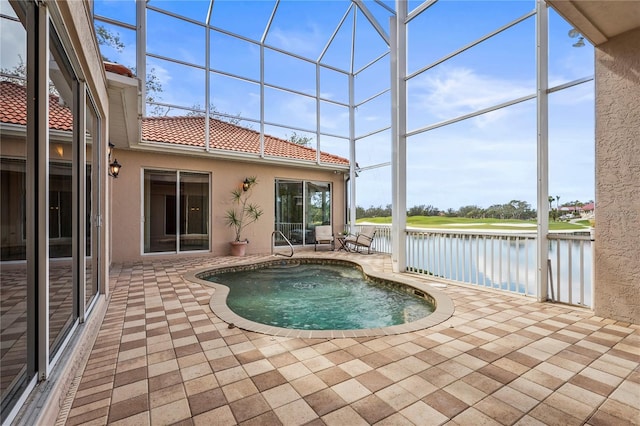 view of swimming pool featuring a patio and a water view