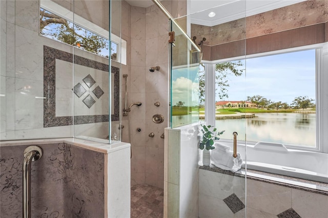 bathroom with tiled shower and a water view