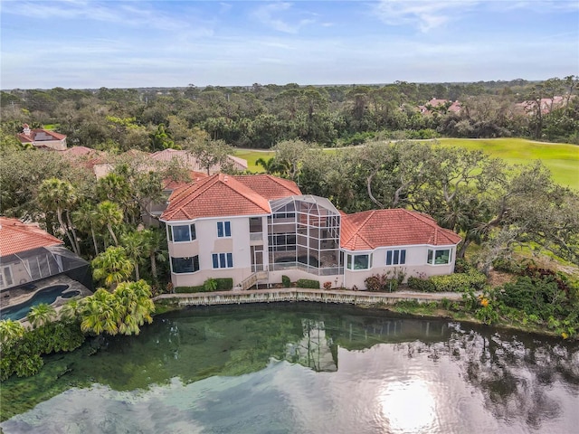 aerial view with a water view and a forest view