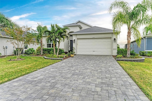 view of front of home with a garage and a front lawn