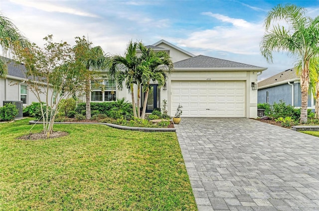 single story home featuring a garage and a front lawn