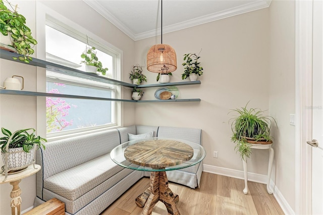 sitting room featuring breakfast area, ornamental molding, and light hardwood / wood-style floors