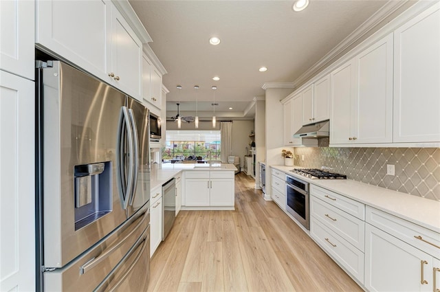 kitchen featuring white cabinetry, light wood-type flooring, appliances with stainless steel finishes, kitchen peninsula, and decorative backsplash