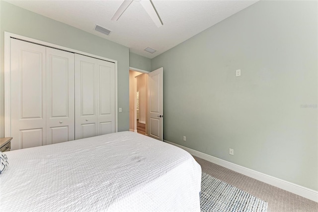 bedroom featuring a closet, ceiling fan, and carpet