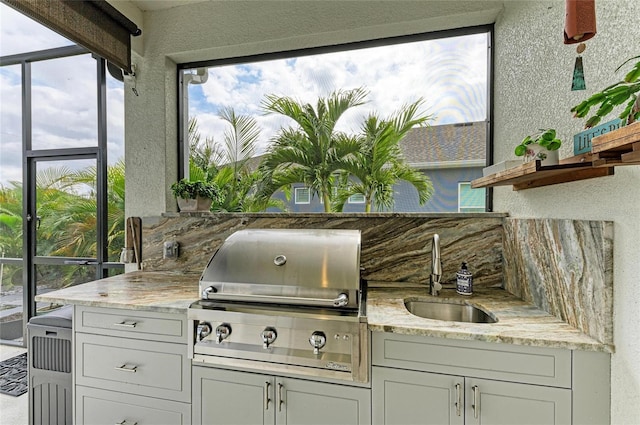 view of patio / terrace with an outdoor kitchen, sink, and area for grilling