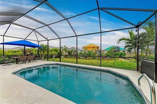 view of swimming pool with a patio, a lanai, and a lawn