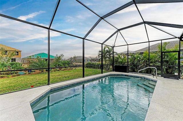 view of swimming pool featuring a patio, a yard, and glass enclosure