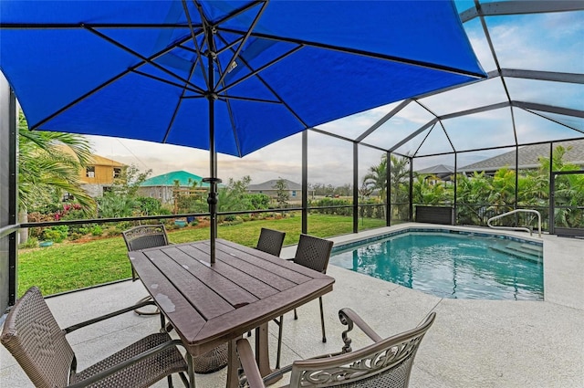 view of pool featuring a patio area, a lawn, and glass enclosure