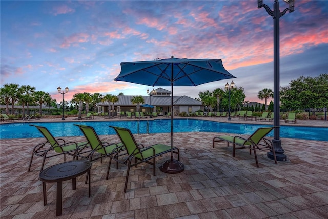 view of pool at dusk