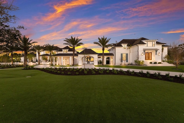 mediterranean / spanish house with a yard and curved driveway