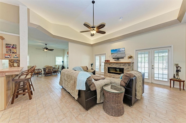 living room featuring ceiling fan, lofted ceiling, light wood-type flooring, and french doors