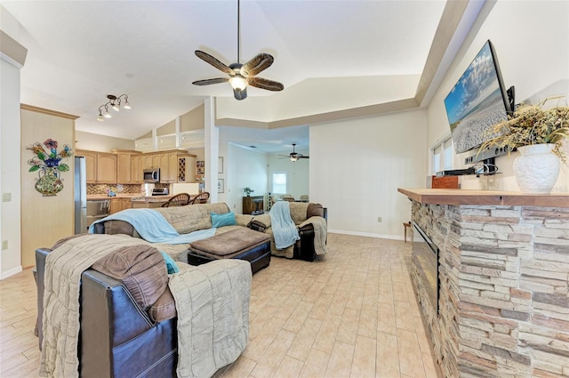 living room featuring vaulted ceiling, ceiling fan, and light hardwood / wood-style floors