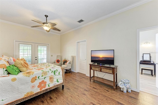 bedroom featuring french doors, a textured ceiling, ornamental molding, hardwood / wood-style flooring, and access to exterior