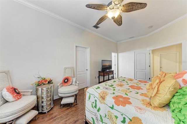 bedroom featuring crown molding, ceiling fan, dark hardwood / wood-style floors, and a textured ceiling