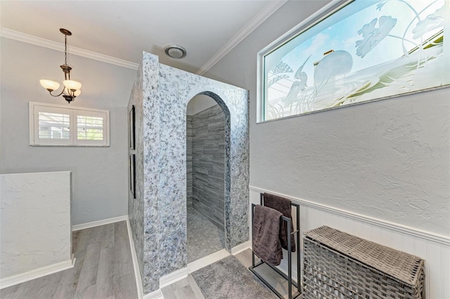 bathroom featuring ornamental molding, wood-type flooring, and a notable chandelier