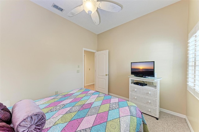 bedroom featuring multiple windows, light carpet, and ceiling fan