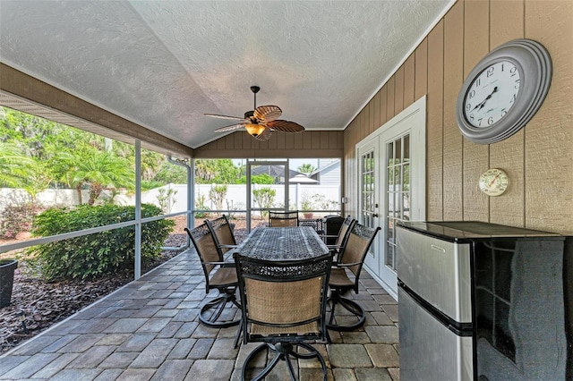 sunroom featuring vaulted ceiling and ceiling fan