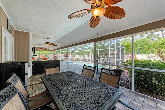 sunroom with vaulted ceiling and ceiling fan