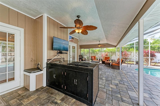 view of patio / terrace with sink, glass enclosure, ceiling fan, an outdoor hangout area, and a fenced in pool