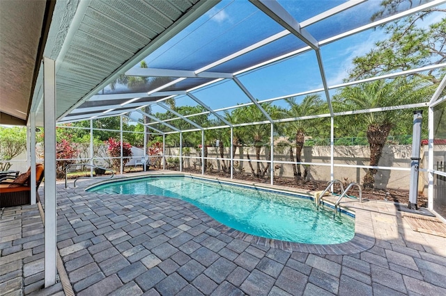 view of swimming pool with a lanai and a patio