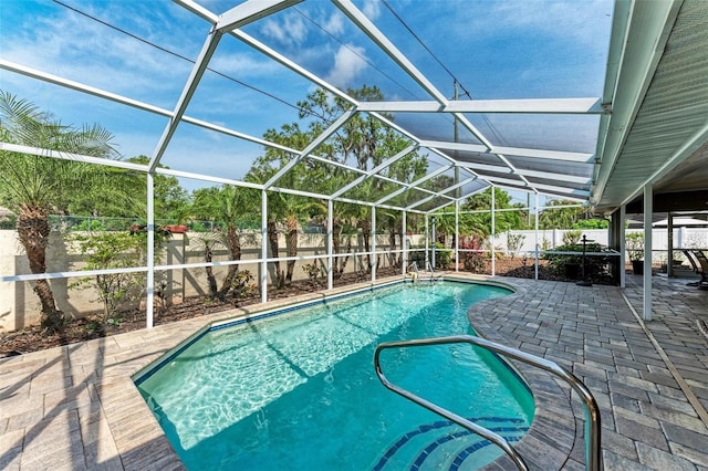 view of pool featuring a patio and glass enclosure