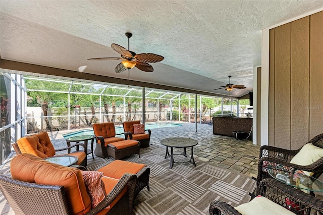 sunroom featuring a wealth of natural light and ceiling fan